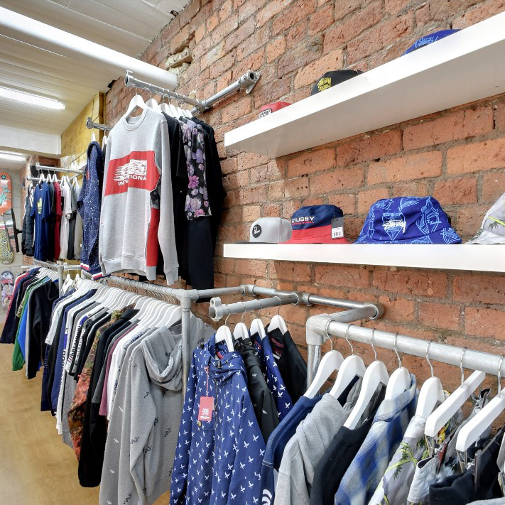 Custom clothes hanging rails in a retail store designed and installed by our customer.