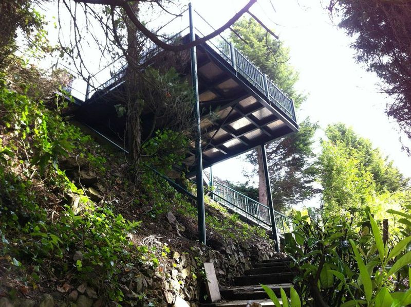 External steel staircase and platform on a wooded hillside