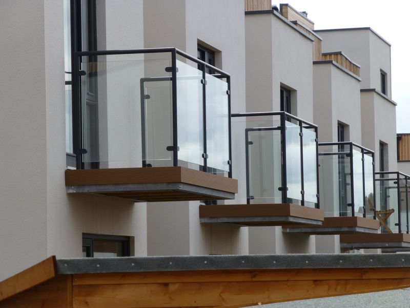 Row of steel-framed glass balconies on new townhouses