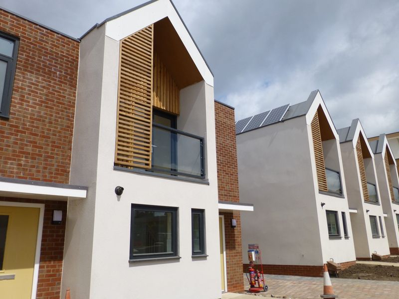 Recessed glass balcony on a gable-fronted new home
