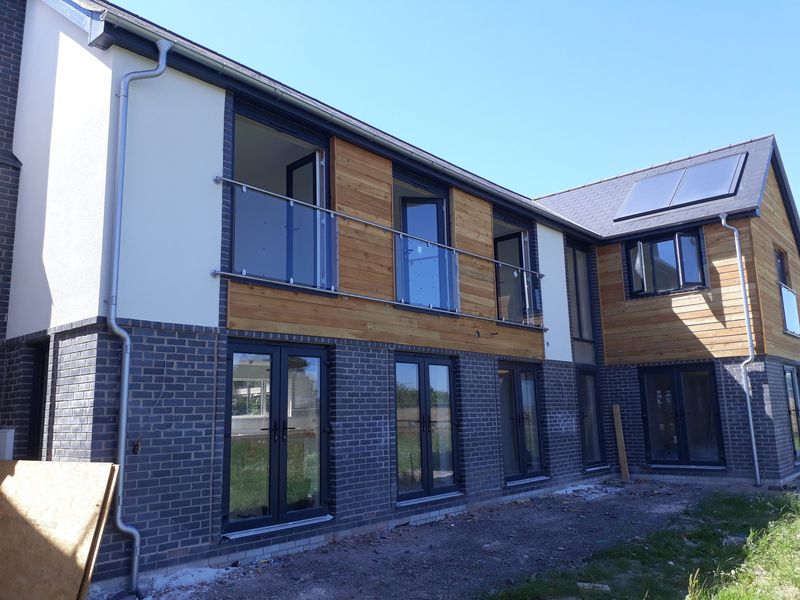 Glass Juliet balconies on a new-build house