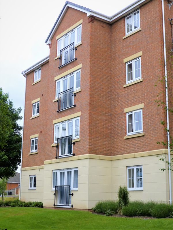 Juliet balconies on every floor of a brick apartment block