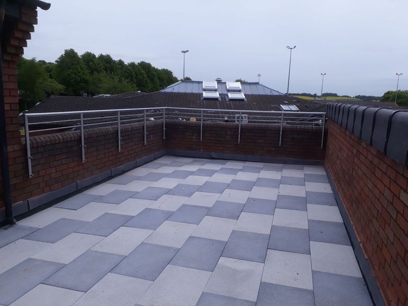 Railing around a paved roof terrace