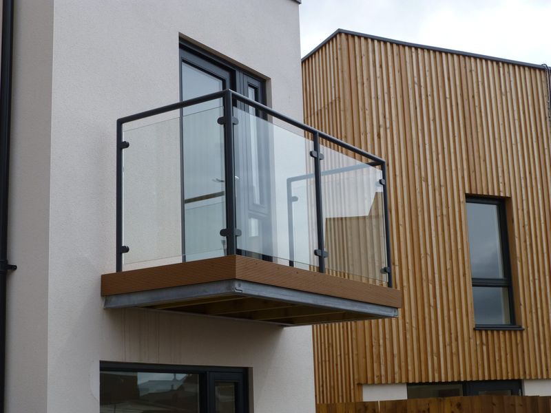 Glass balcony with stainless steel clamps and handrail