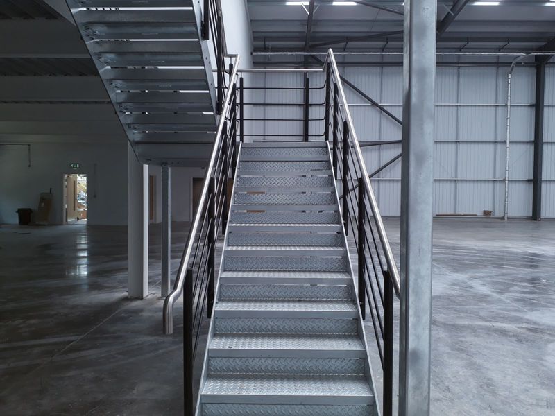 Steel staircase leading to a mezzanine floor